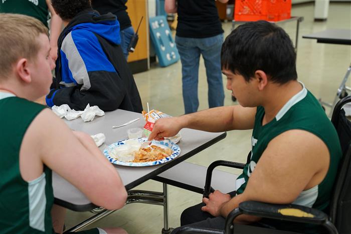 Students eat pizza after the Pathfinder Panthers Basketball Team played against the Mon Valley Mustangs Feb. 22, 2024.